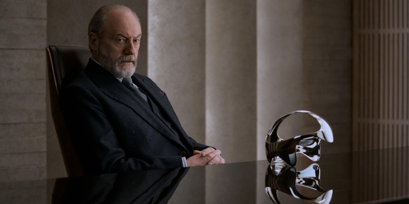 Liam Cunningham as Thomas Wade sits at a desk and looks serious in 3 Body Problem