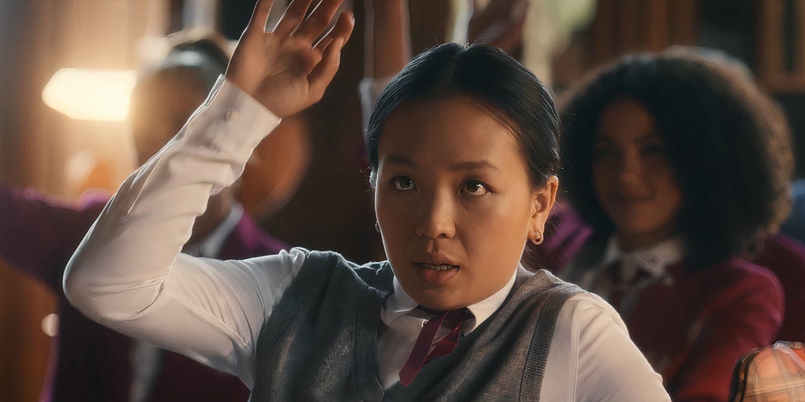 Andrea Guo as Lin Wang raising her hand and looking ashamed in Maxton Hall: The World Between Us