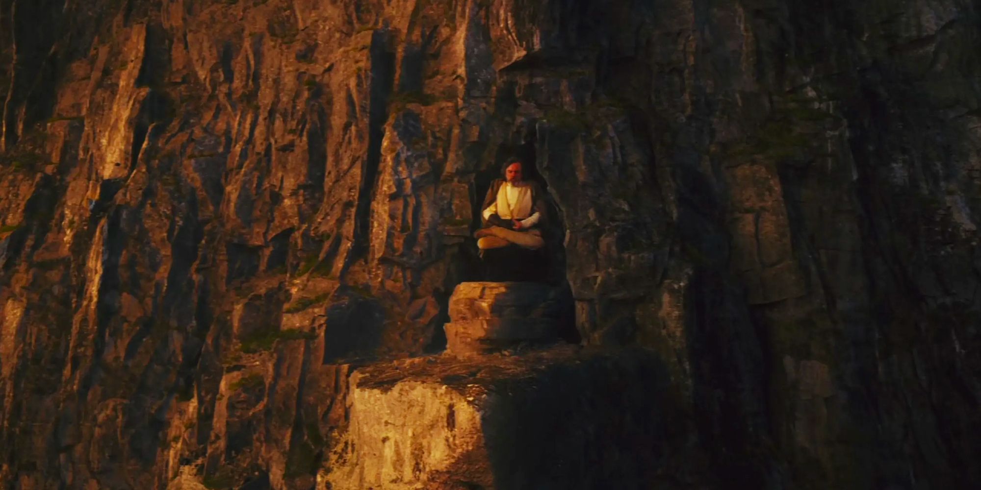 Luke Skywalker floating in the air on the cliffs of Ahch-To in Star Wars: The Last Jedi.