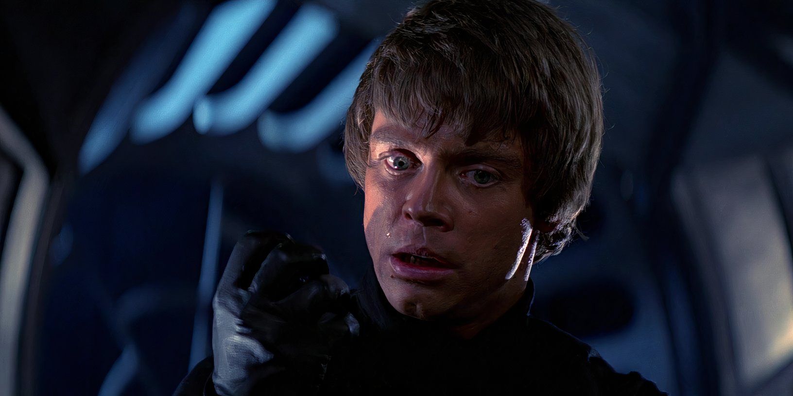 Luke Skywalker (Mark Hamill) looks down at his clenched fist while standing over a defeated Darth Vader in Return of the Jedi