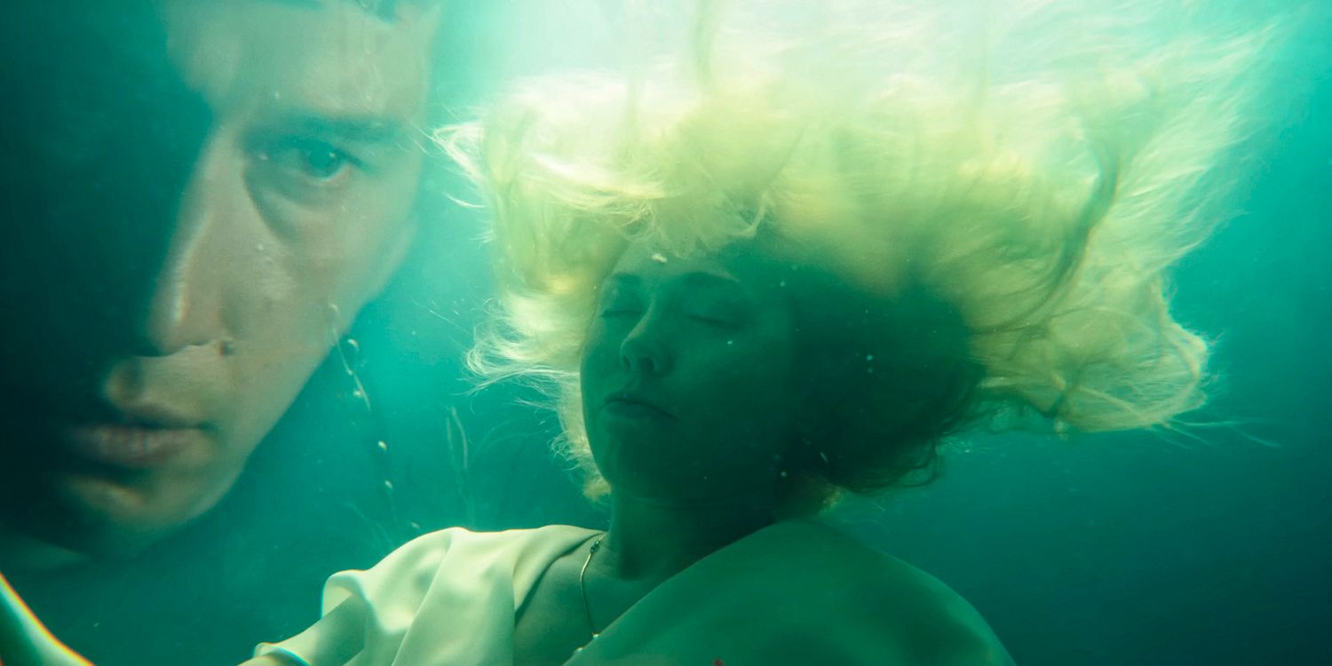 A woman submerged in water with Caesar Catalina's (Adam Driver) face appearing in the background in Megalopolis