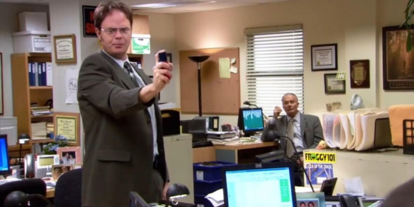 Dwight (Rainn Wilson) holds up pepper spray in The Office