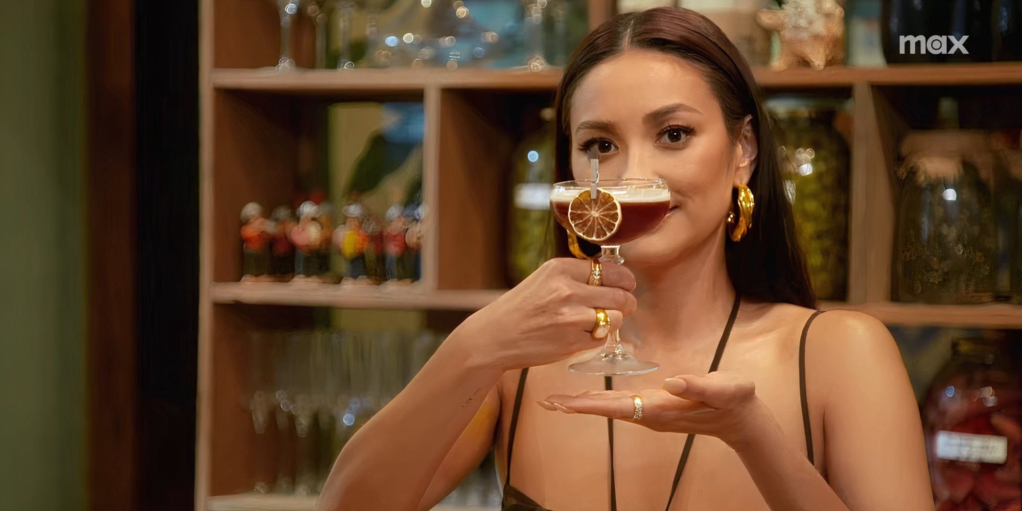 Shay Mitchell posing with a drink