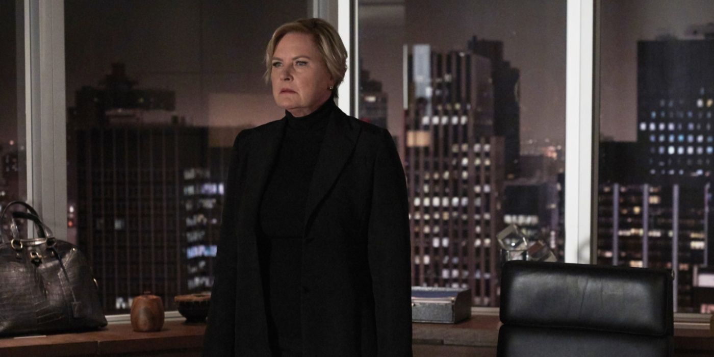 Faye (Denise Crosby) stands in front of the city skyline in Suits