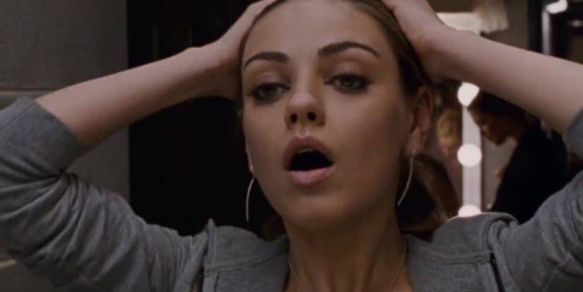 Odile (Mila Kunis) looking in the mirror in Black Swan