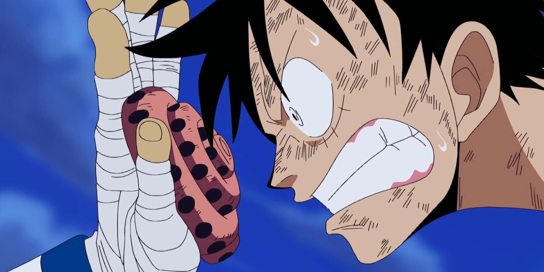 Luffy looks angrily at Usopp's hand weapon