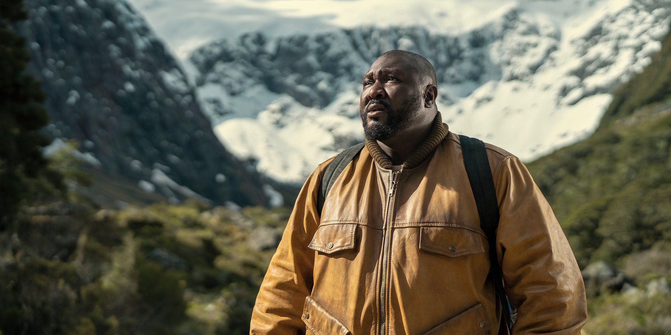 Nonso Anozie as Big Man looking worried up at the mountains in Sweet Tooth season 3