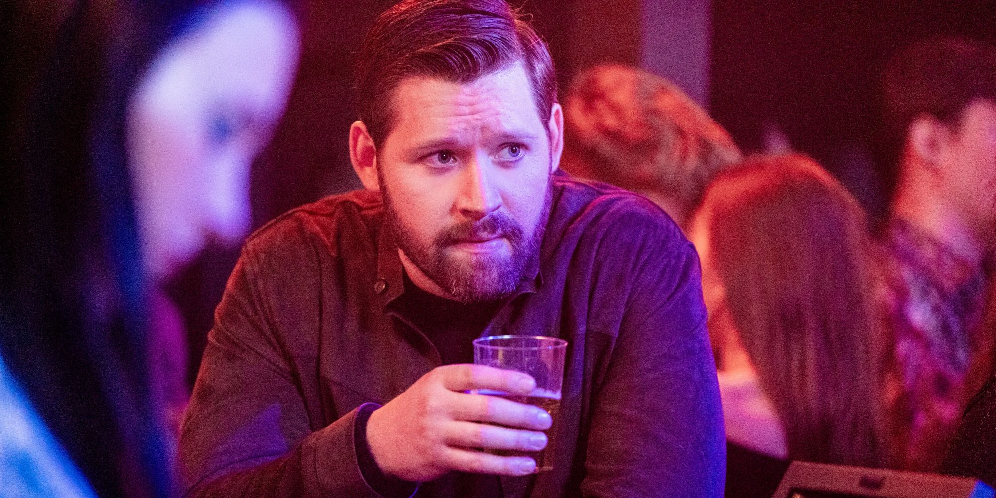 Luke Kleintank as Scott Forrester sips a drink on FBI: International season 3