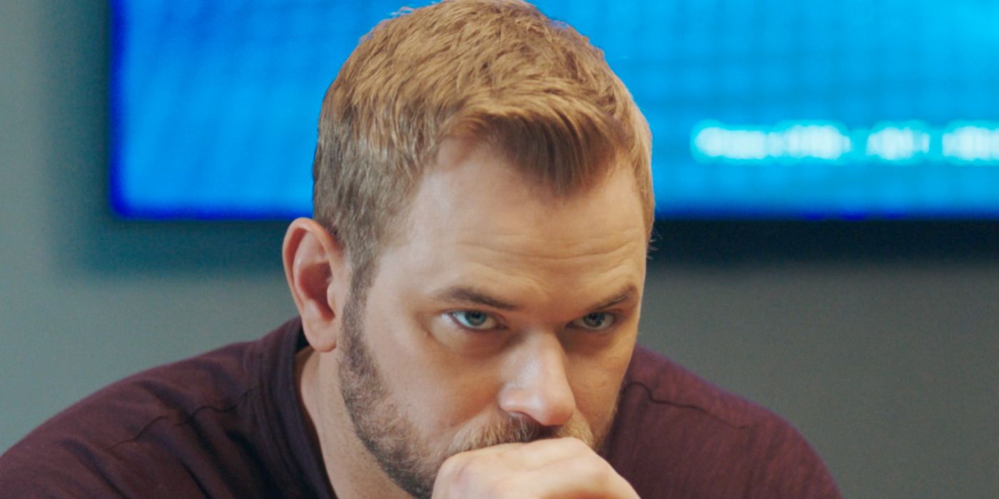 Kenny Corsby (Kellan Lutz) resting his head on his hands in FBI: Most Wanted