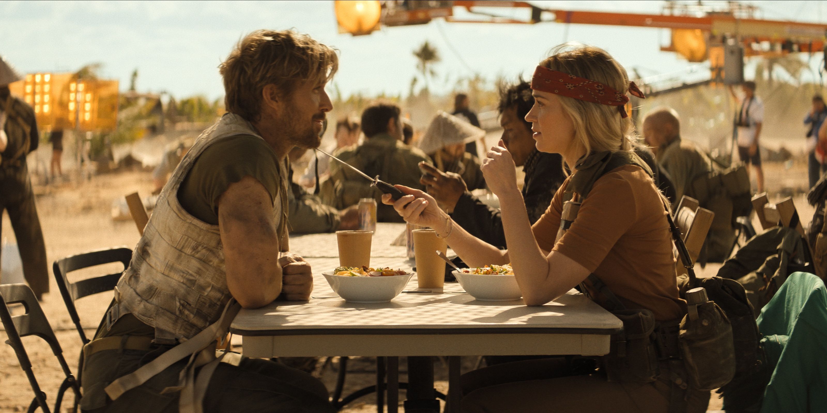 Ryan Gosling and Emily Blunt chat at a table on the set of Metalstorm in The Fall Guy movie