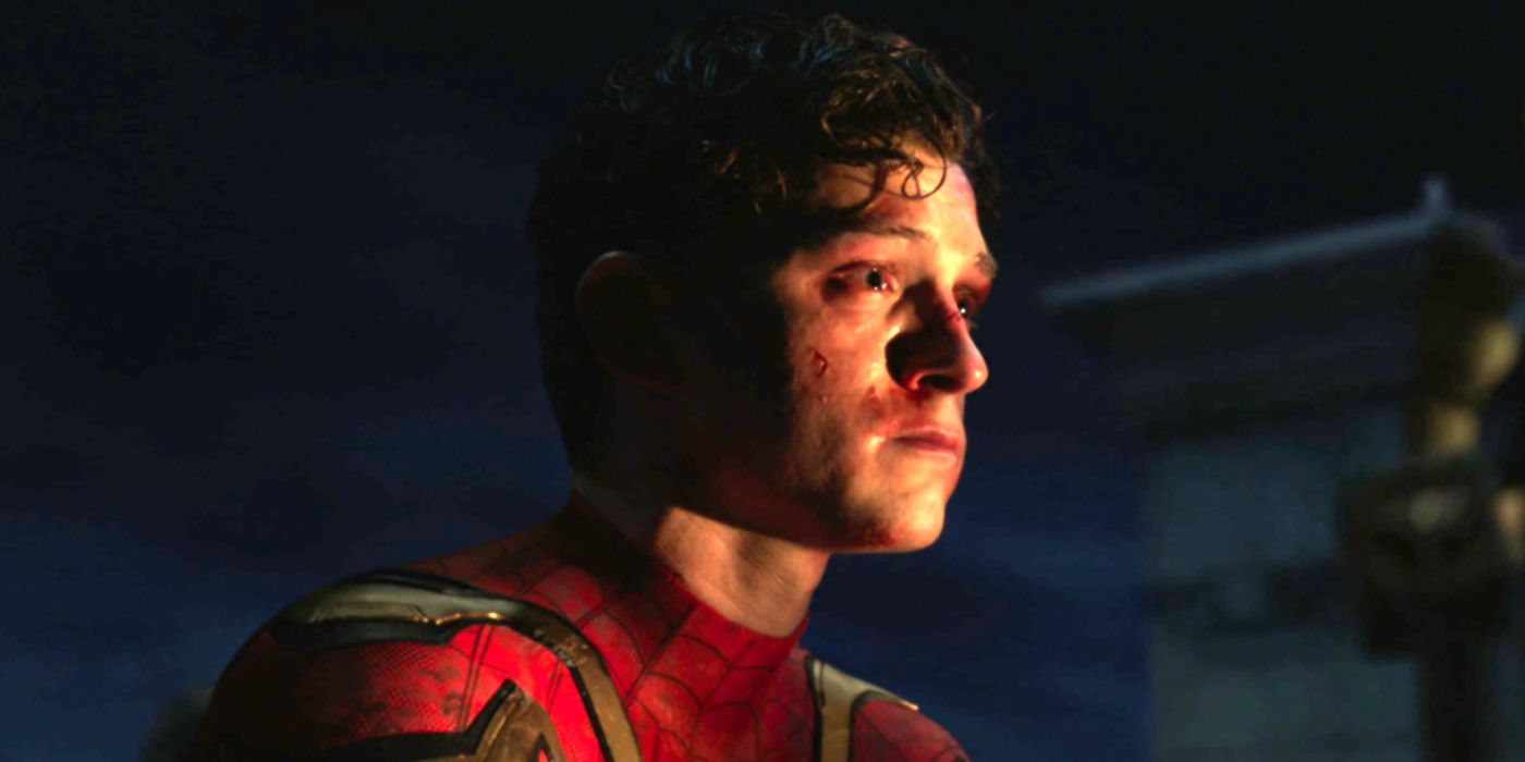 Tom Holland as Peter Parker crying on a rooftop in Spider-Man: No Way Home