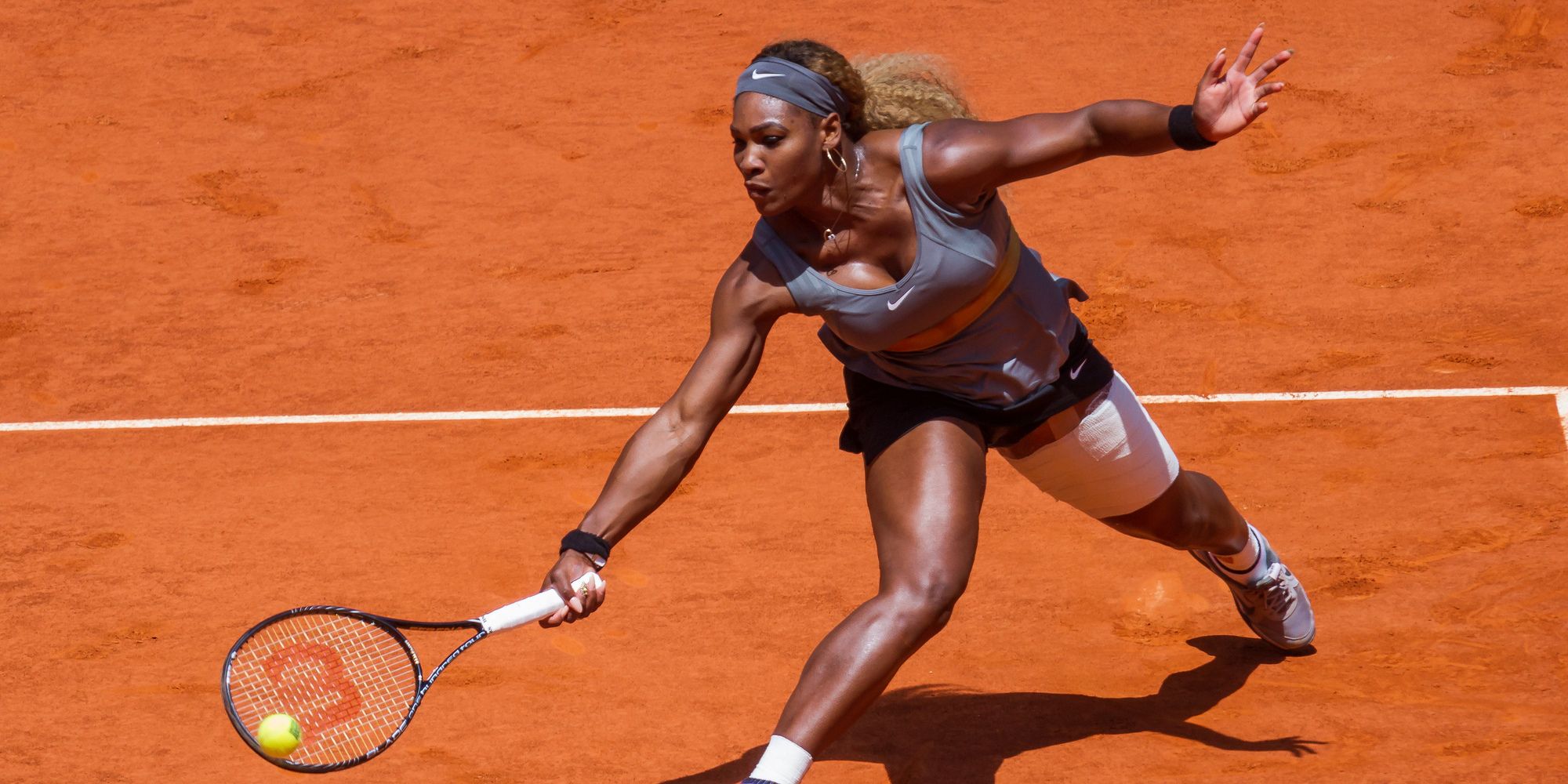 Serena Williams Playing Tennis On Clay Court With Ball About To Hit Racket.jpg