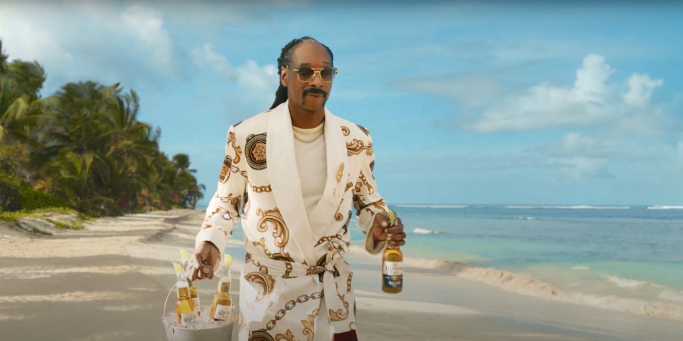 Snoop Dogg walkling on the beach carrying beers in a Corona commercial.