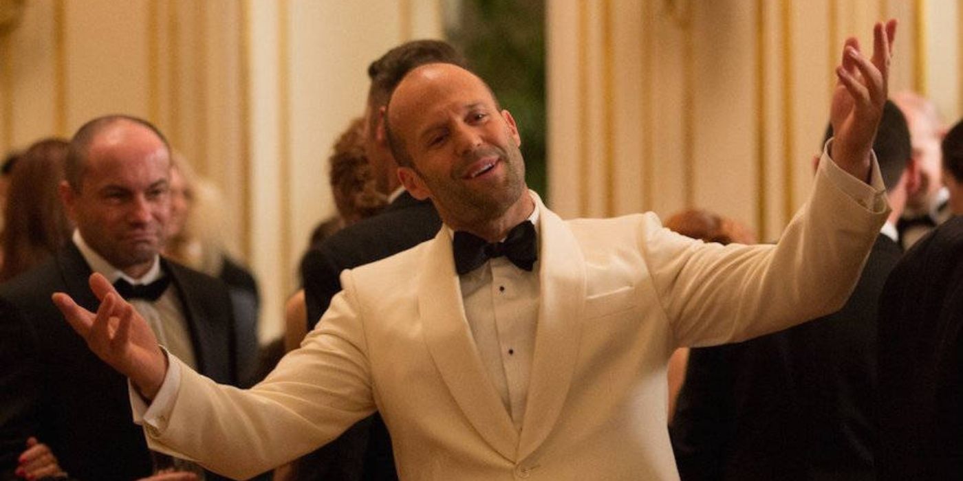 Jason Statham wearing a white suit and smiling in Spy