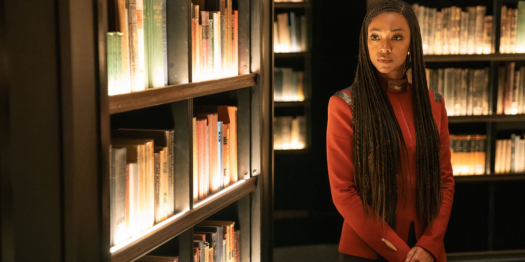 Sonequa Martin-Green as Captain Michael Burnham, surrounded by rows of bookshelves in Star Trek: Discovery season 5, episode 8