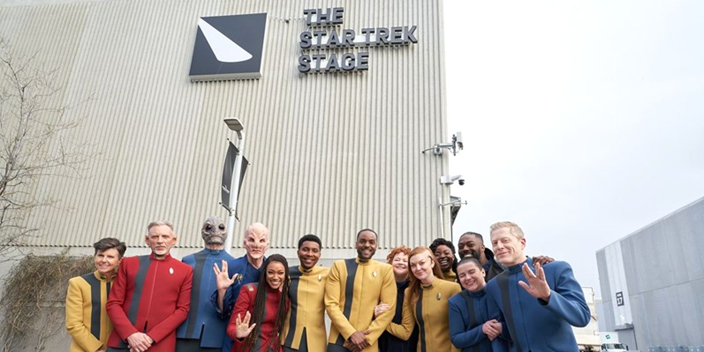 Star Trek Discovery cast posing in front of Star Trek Stage in Toronto