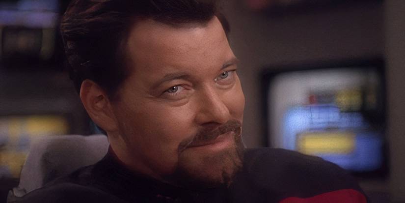 Thomas Riker removes his fake sideburns and grins in Star Trek: DS9