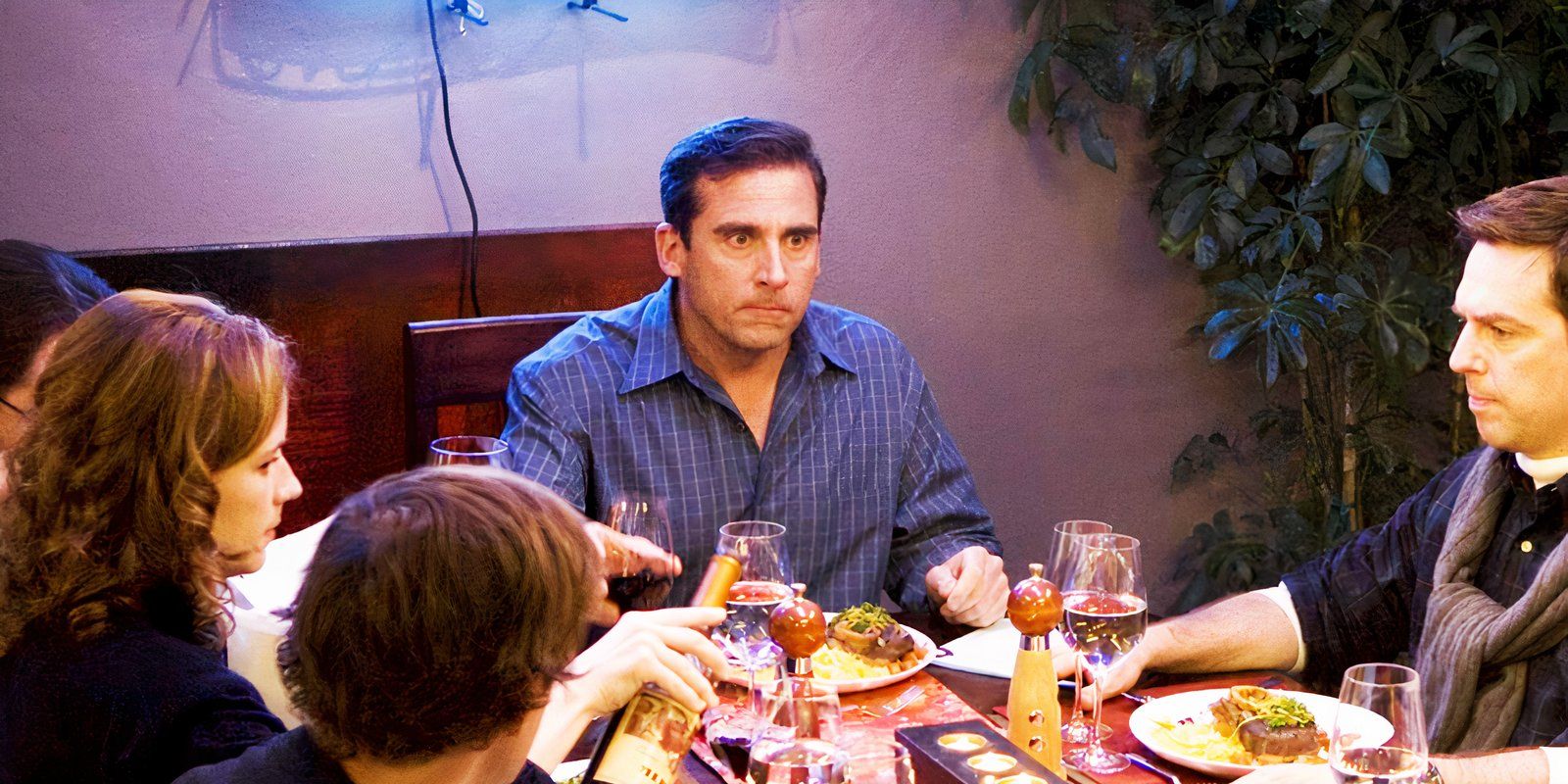 Steven Carell as Michael with a large neon sign behind him in The Office's Dinner Party episode