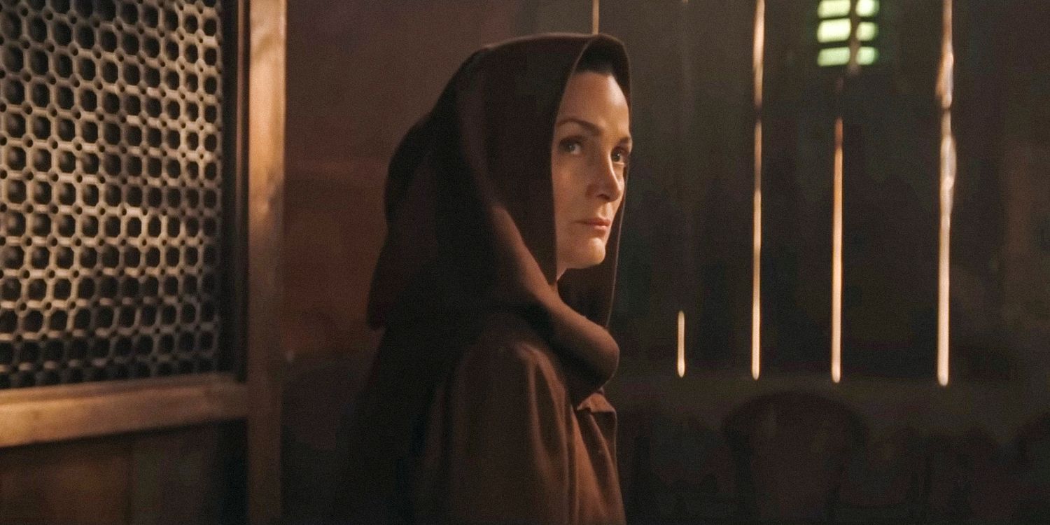 Carrie-Ann Moss as a Jedi in The Acolyte wearing a robe looking over her shoulder in The Acolyte - S1 [STAR WARS] 