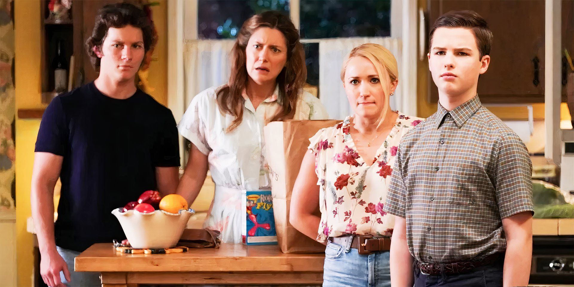 The cast of Young Sheldon standing around the kitchen