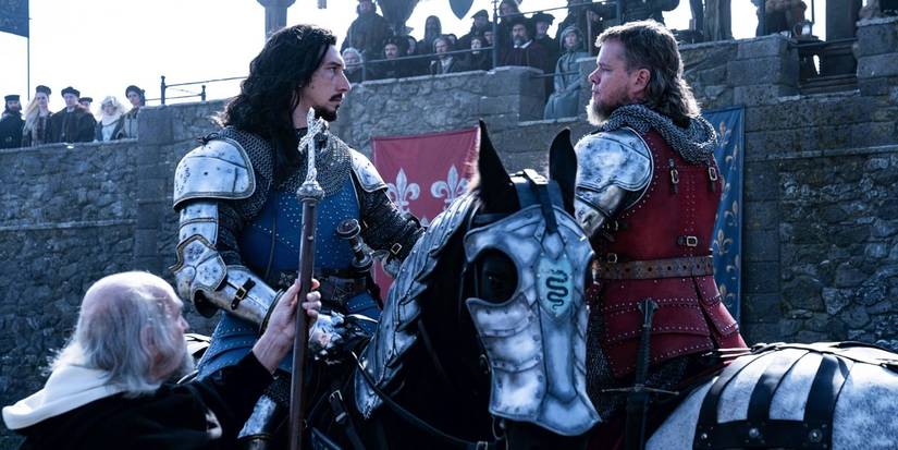 Matt Damon and Adam Driver look at each other at a tournament in The Last Duel
