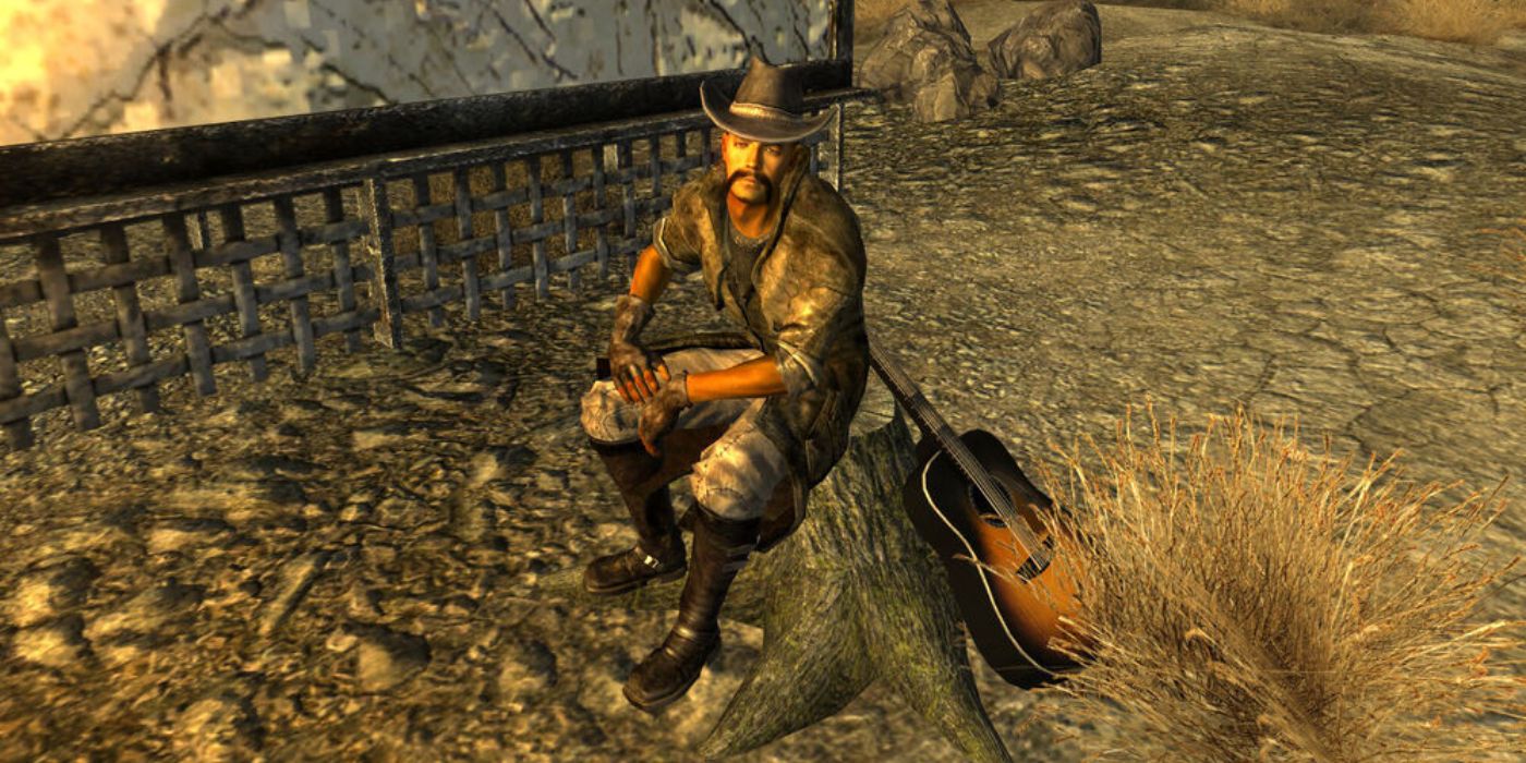 The Lonesome Drifter sits on a tree stump, his guitar leaning on the opposite side of it in a screenshot from Fallout New Vegas.