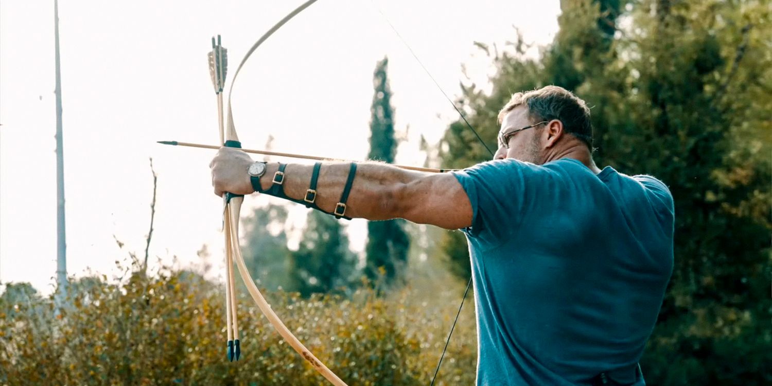 Anders Lassen (Alan Ritchson) shooting an arrow in The Ministry of Ungentlemanly Warfare