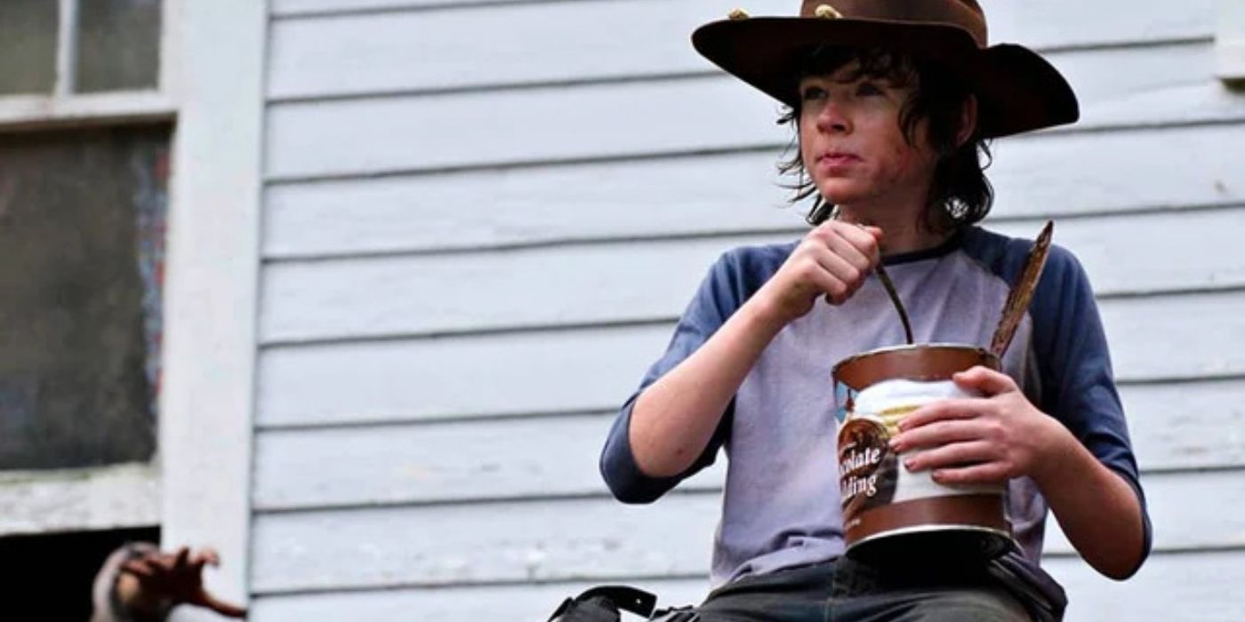 The Walking Dead's Carl eating a can of food.