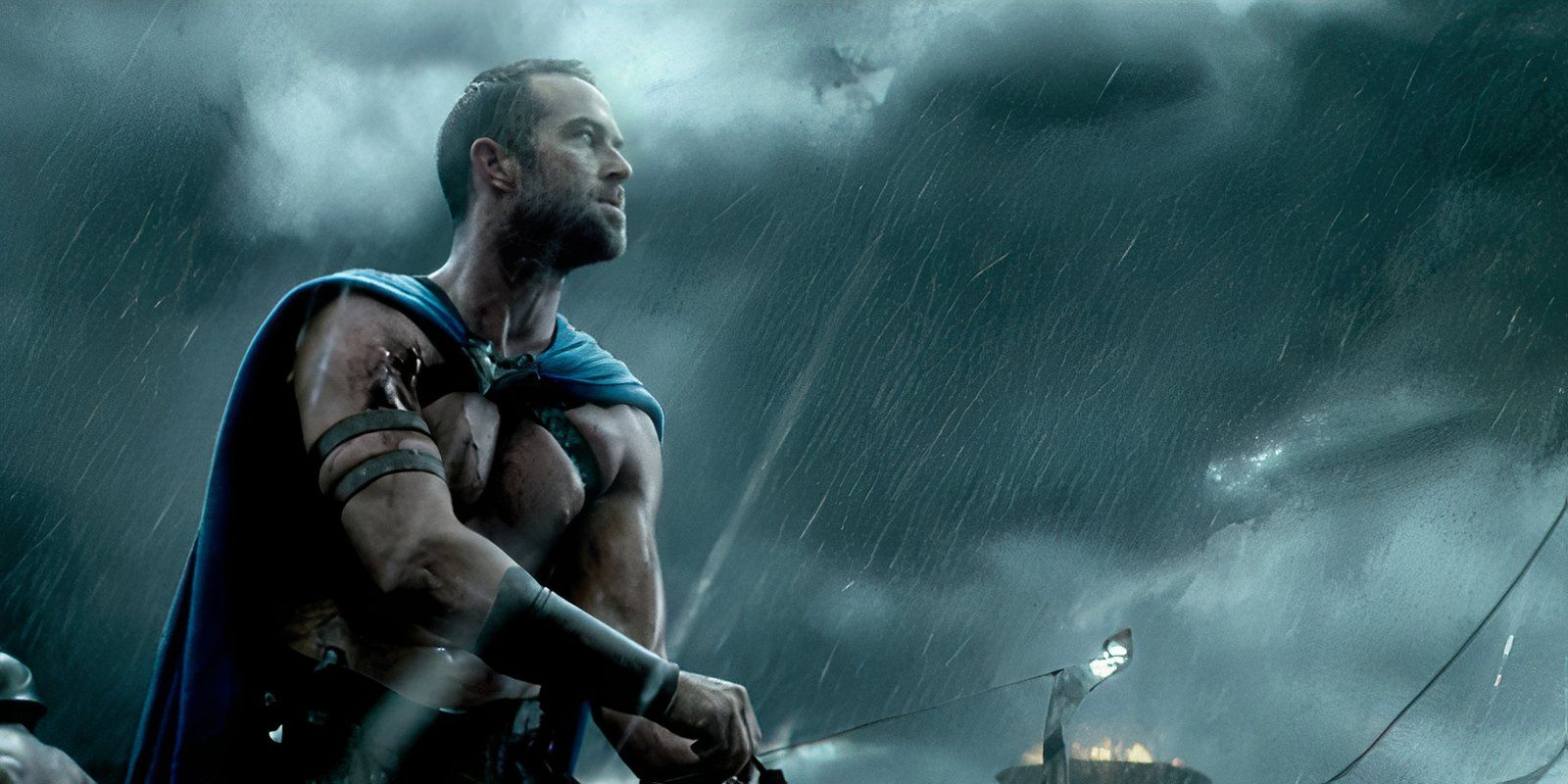 Themistocles stands in rain against a blue sky in 300 Rise Of An Empire