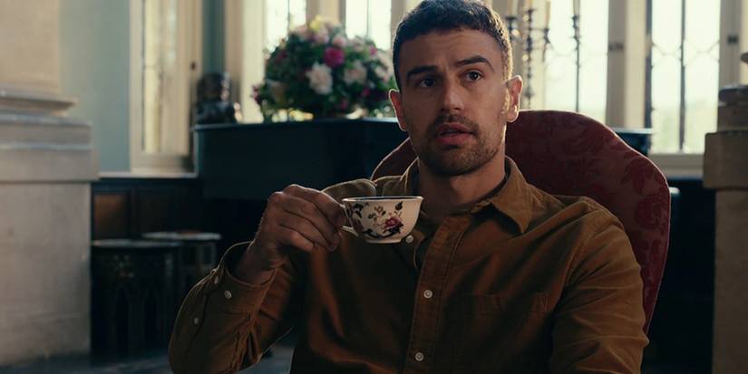 Theo James Holding a Teacup in The Gentlemen