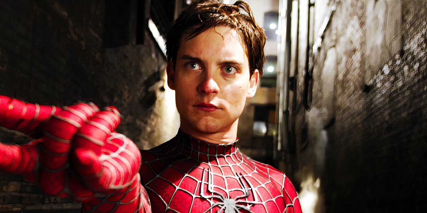 Tobey Maguire as Spider-Man, using his web-shooter as he stands in an alleyway.