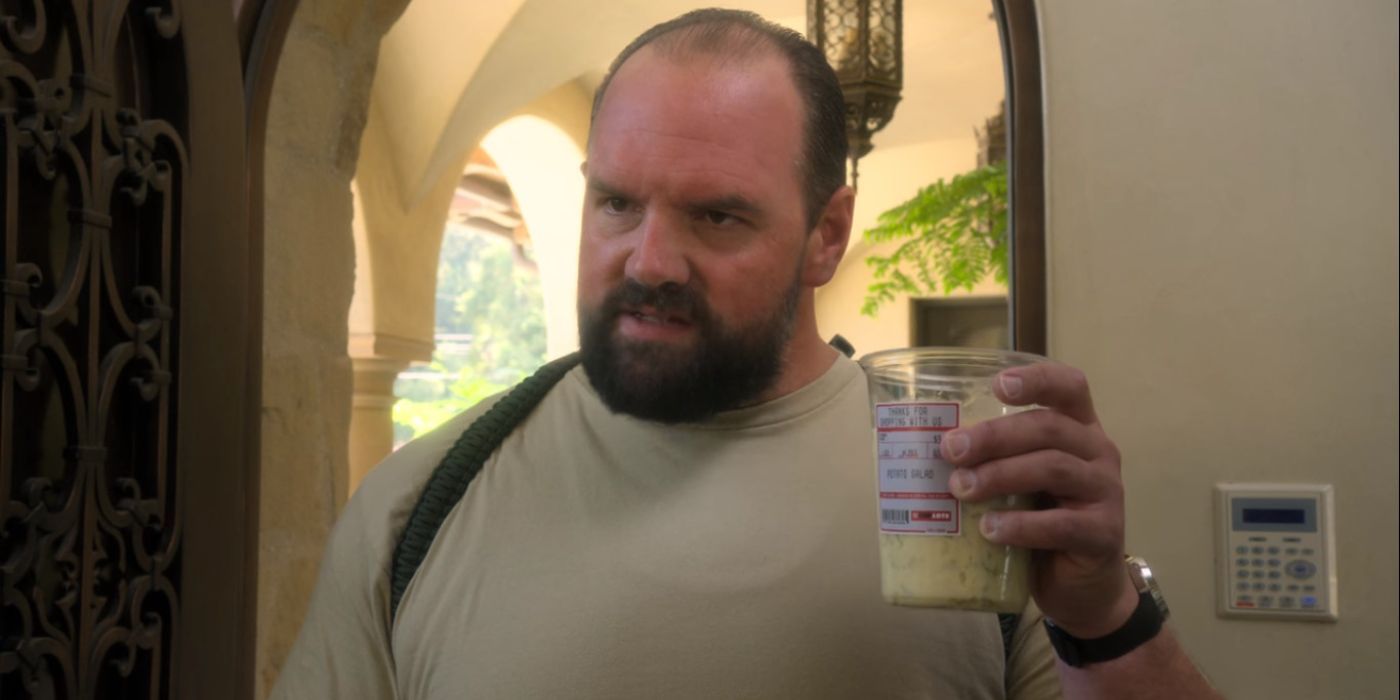 Tommy (Ethan Suplee) looking angry and holding an iced coffee in Santa Clarita Diet.