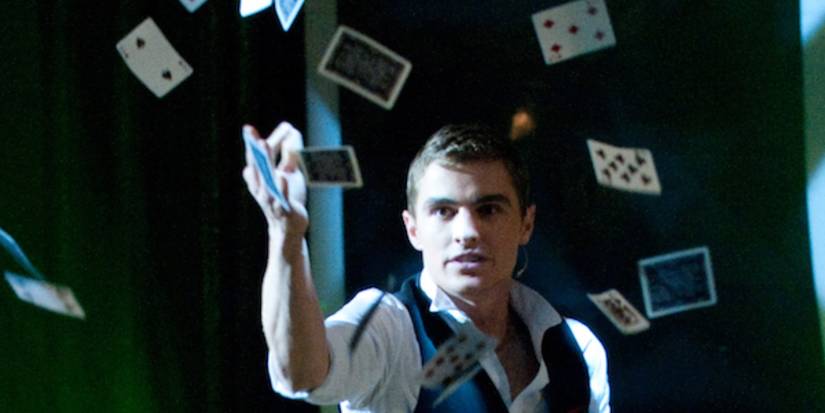 Dave Franco throwing cards in the air in Now You See Me