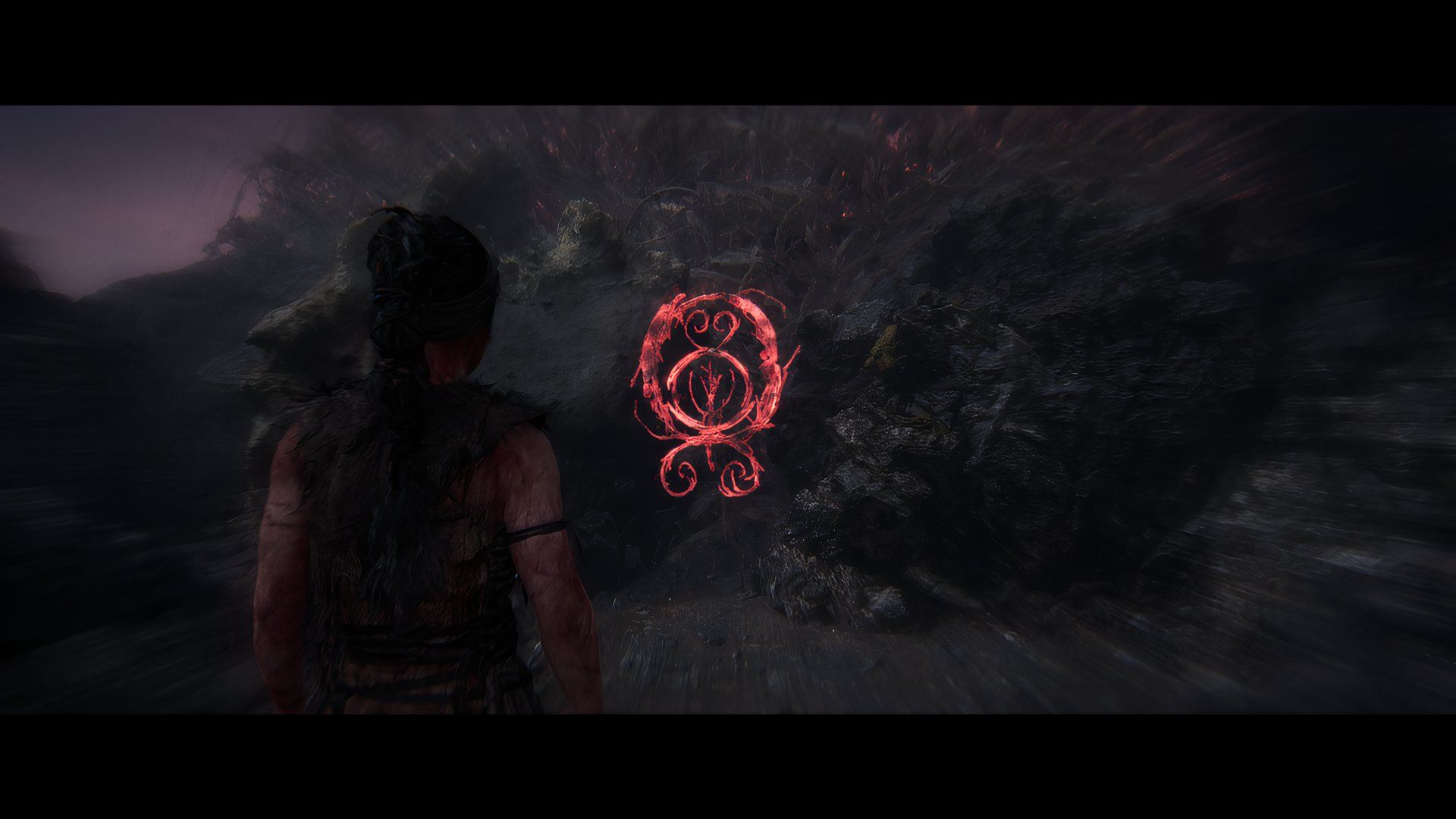 Senua looking at a sigil for a puzzle in the game. 