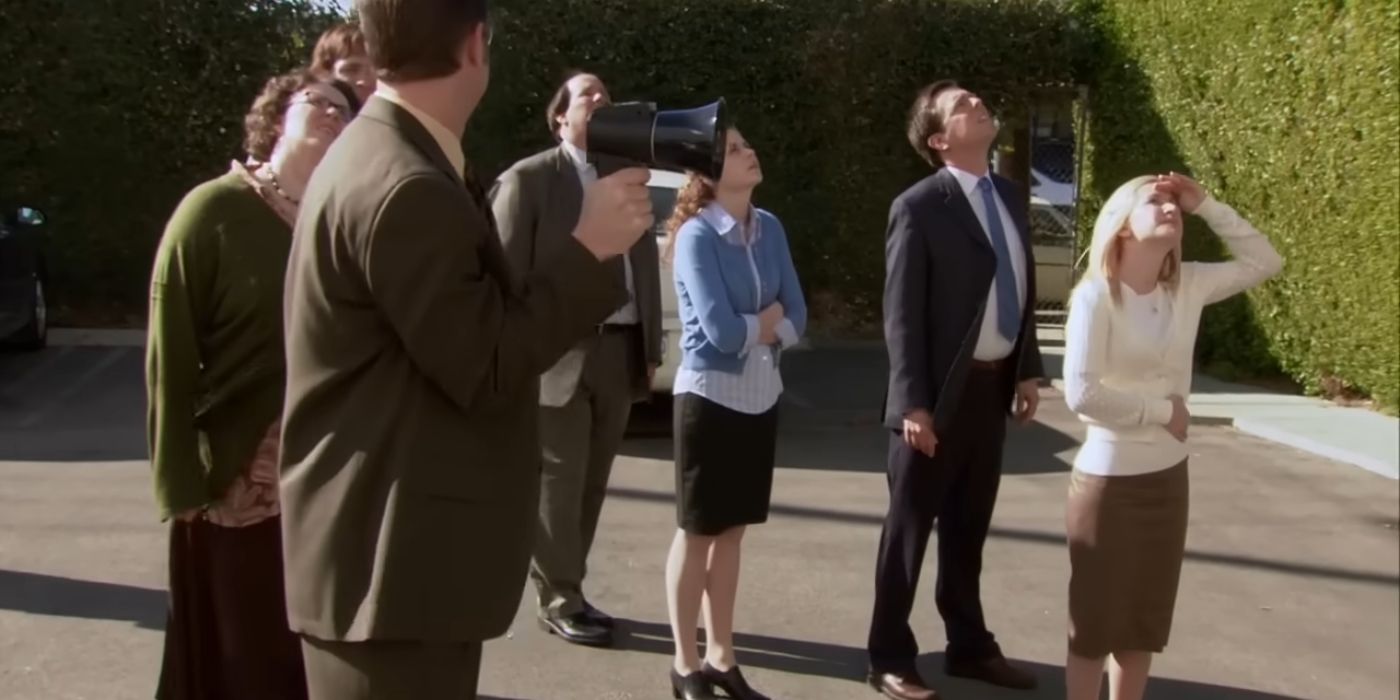 Phyllis, Jim, Dwight, Kevin, Pam, Andy, and Angela watching Michael on the roof of the building in The Office episode Safety Training