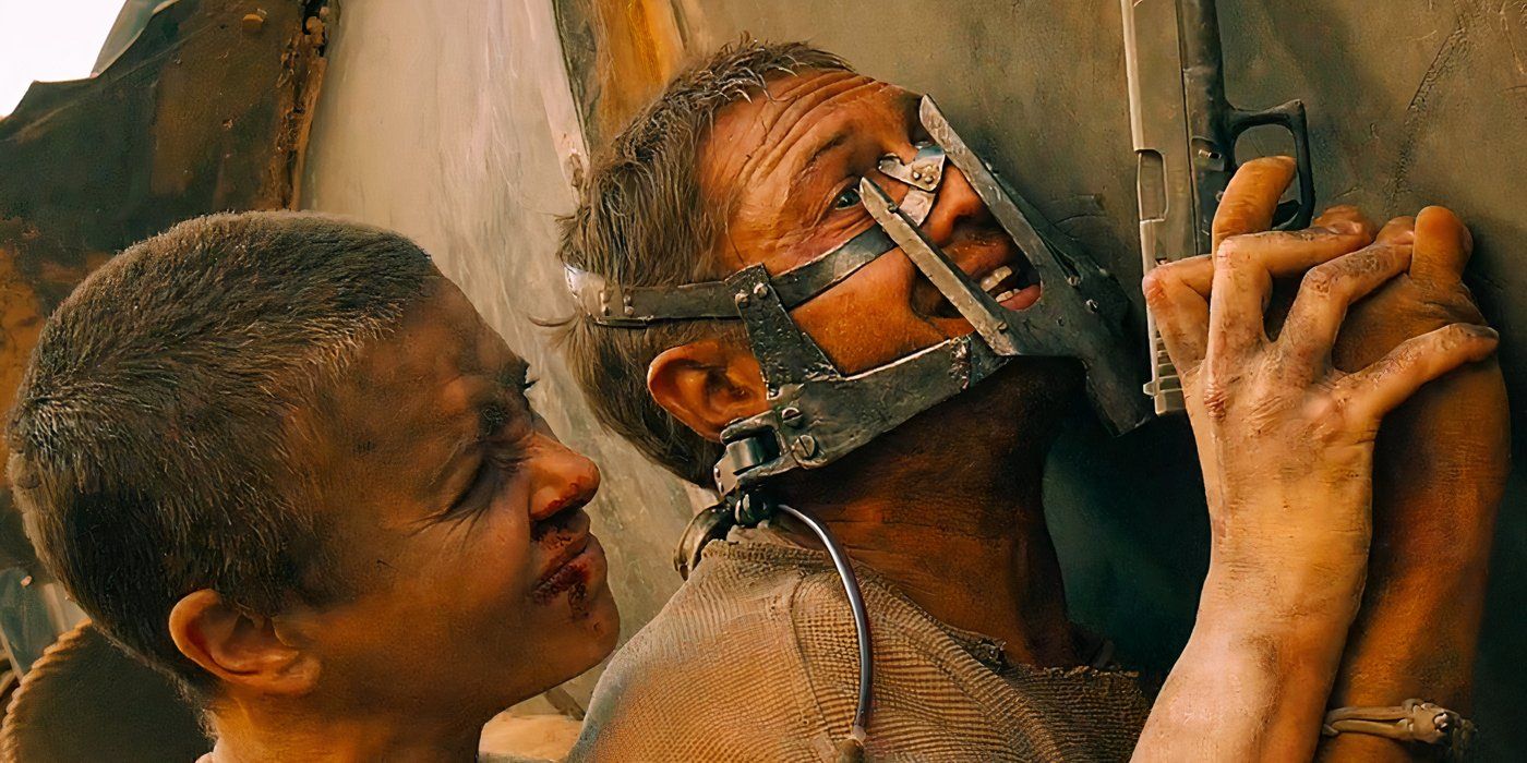 Charlize Theron as Furiosa pressing a masked Tom Hardy as Max against a rig in Mad Max: Fury Road