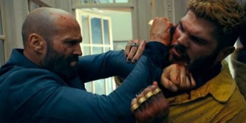 Jason Statham as Adam Clay and Taylor James as Lazarus fighting in The Beekeeper (2024)