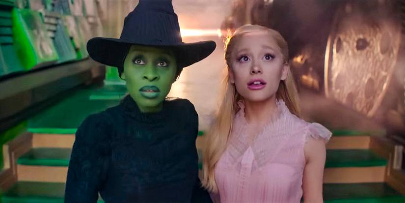 Glinda (Ariana Grande) and Elphaba (Cynthia Erivo) looking at something in surprise in Wicked 