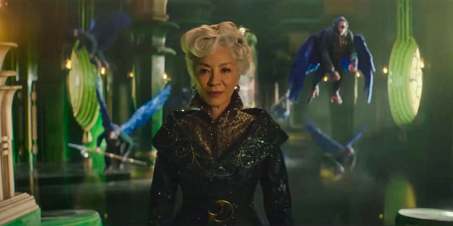 Michelle Yeoh as Madame Morrible standing in front of flying monkeys in Wicked 