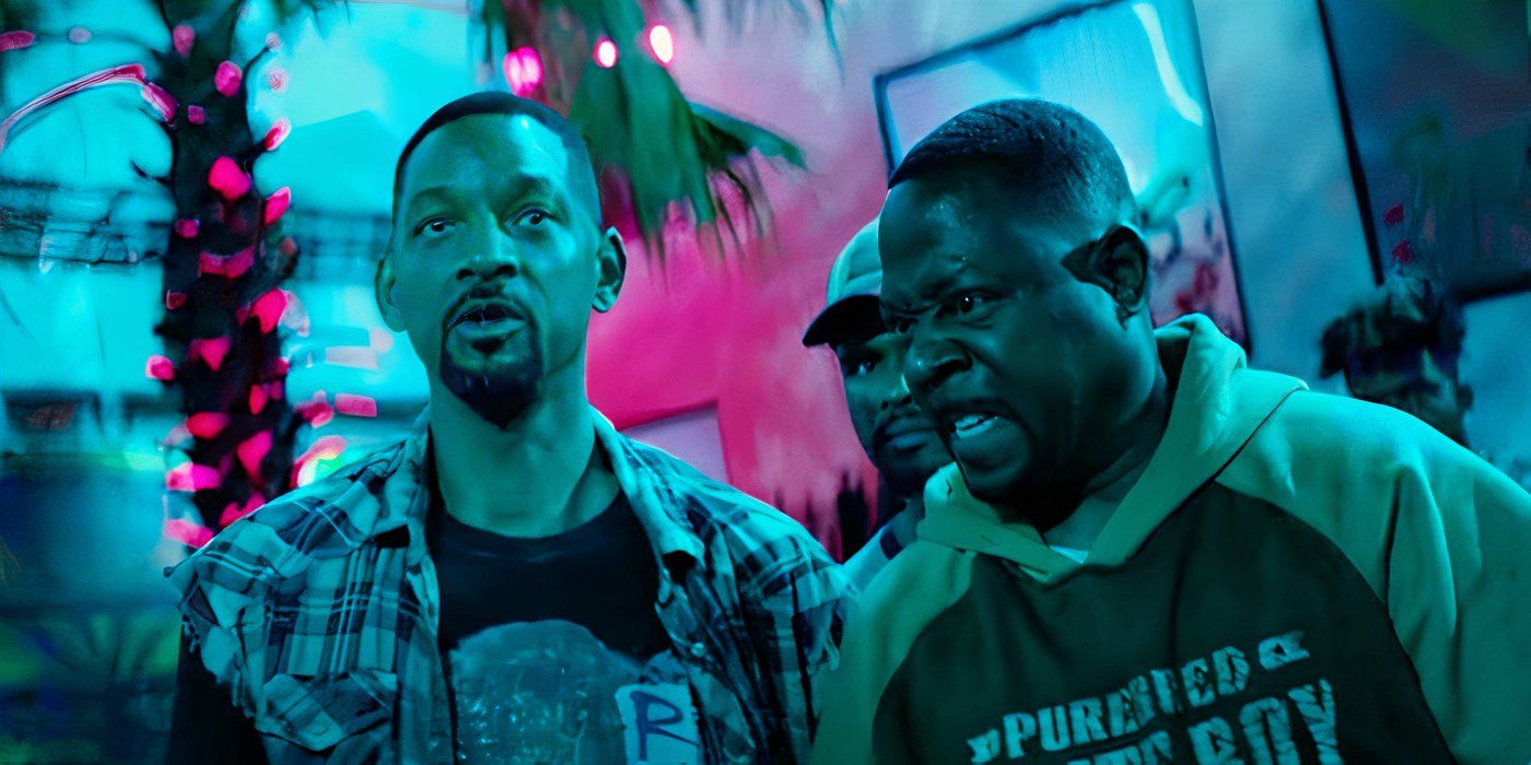 Will Smith looking in the distance while Martin Lawrence whispers intensely to him in Bad Boys Ride or Die