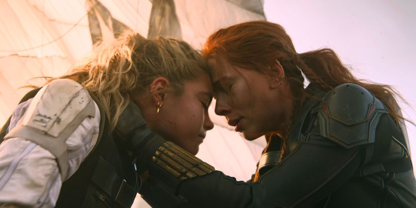 Yelena Belova (Florence Pugh) and Natasha Romanoff (Scarlett Johansson) embrace after reuniting in Black Widow (2021)