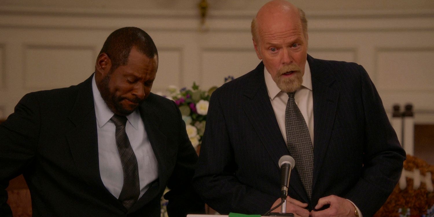 Coach Wayne (Doc Farrow) and Petersen (Rex Linn) giving speeches for their friend George at his funeral in Young Sheldon season 7 episode 13