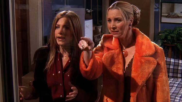A shocked Phoebe and Rachel look out the window in Friends
