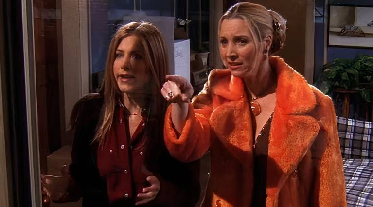 A shocked Phoebe and Rachel look out the window in Friends