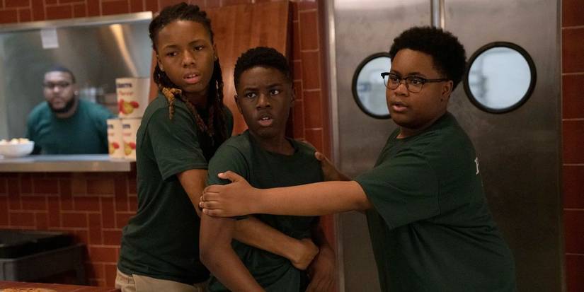 Alex Hibbert as Kevin Williams being held back by his friends in The Chi