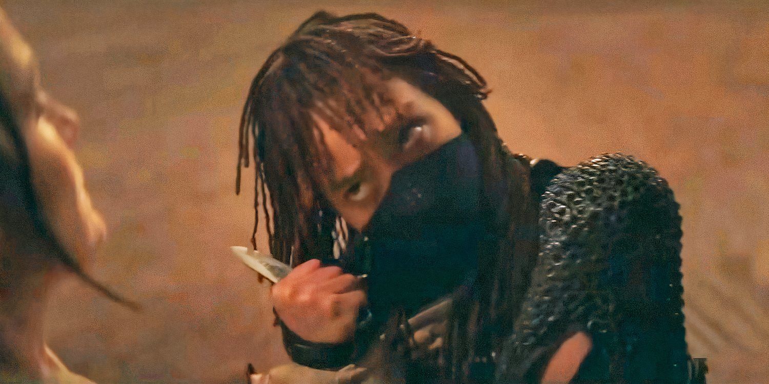Amandla Stenberg as Mae wearing a bandana and threatening with a dagger in The Acolyte