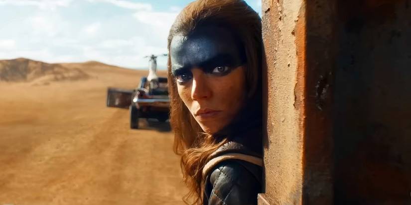 Anya Taylor-Joy as Furiosa Peeking Around a Corner in Furiosa: A Mad Max Saga