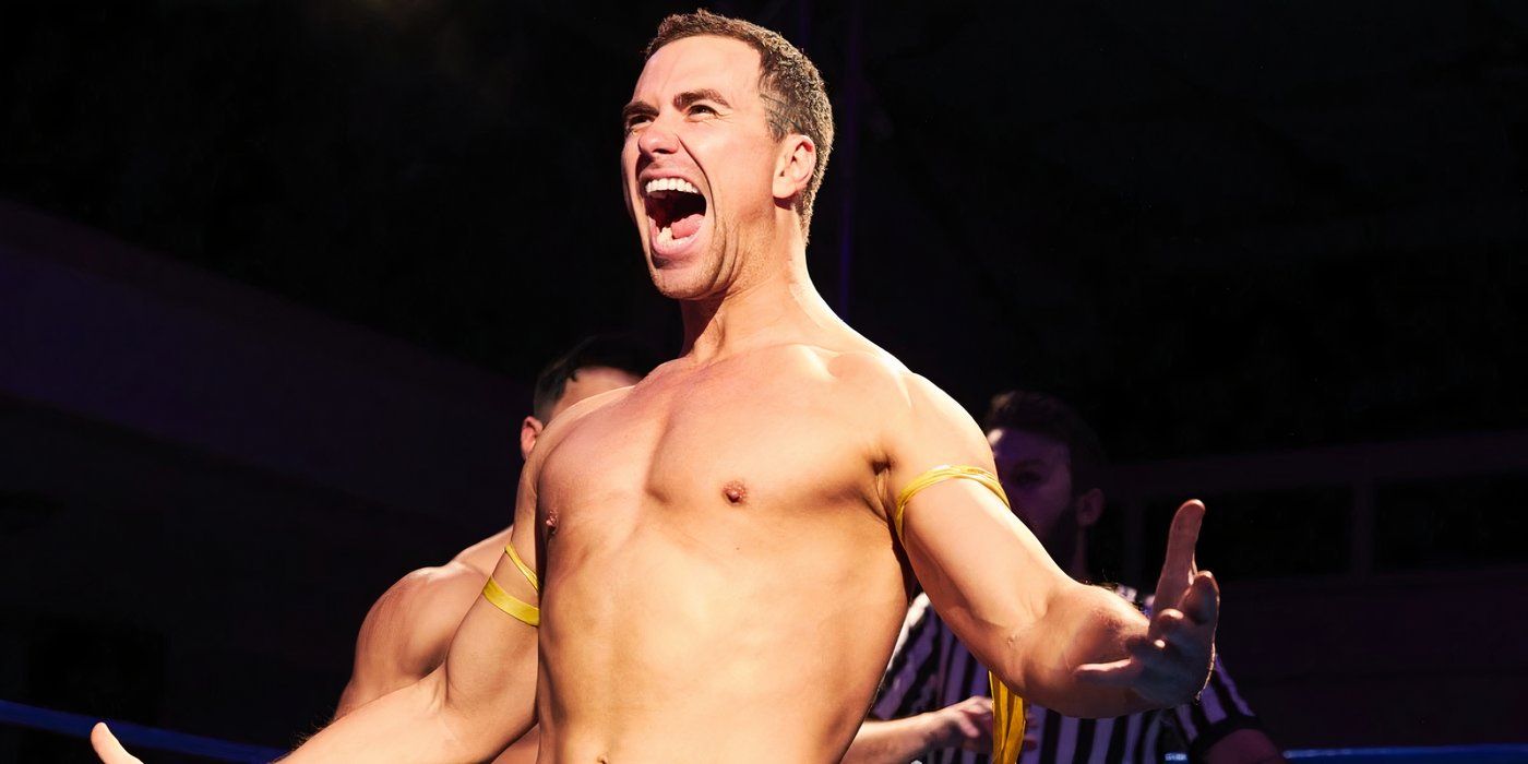 Richard Fleeshman shouts while flexing his muscles in a wrestling ring