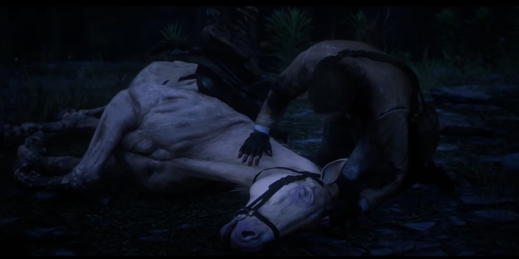 Arthur from Red Dead 2 crouches beside and comforts his dying horse. 