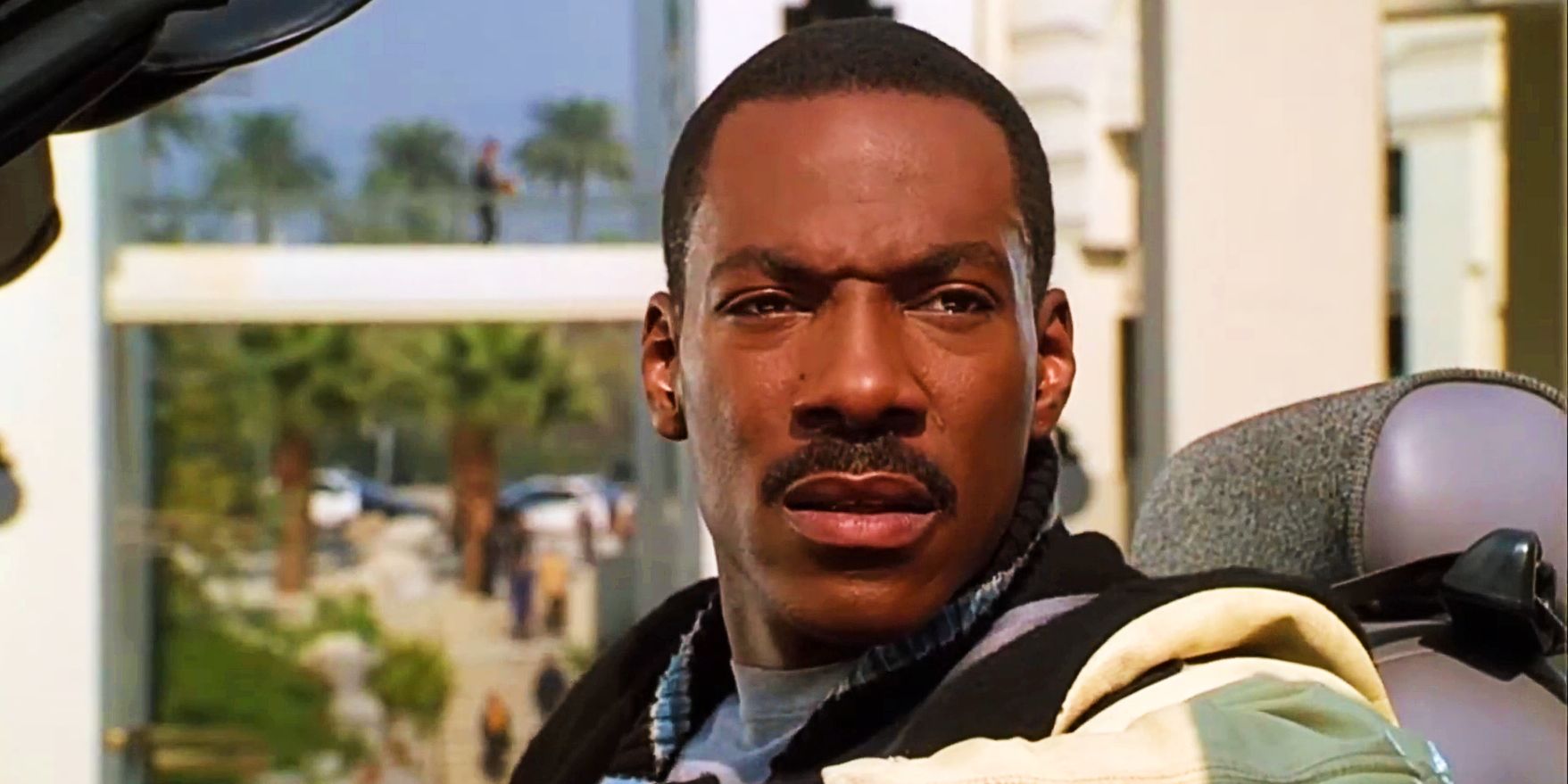 Axel Foley in a car staring incredulously at something in Beverly Hills Cop 3
